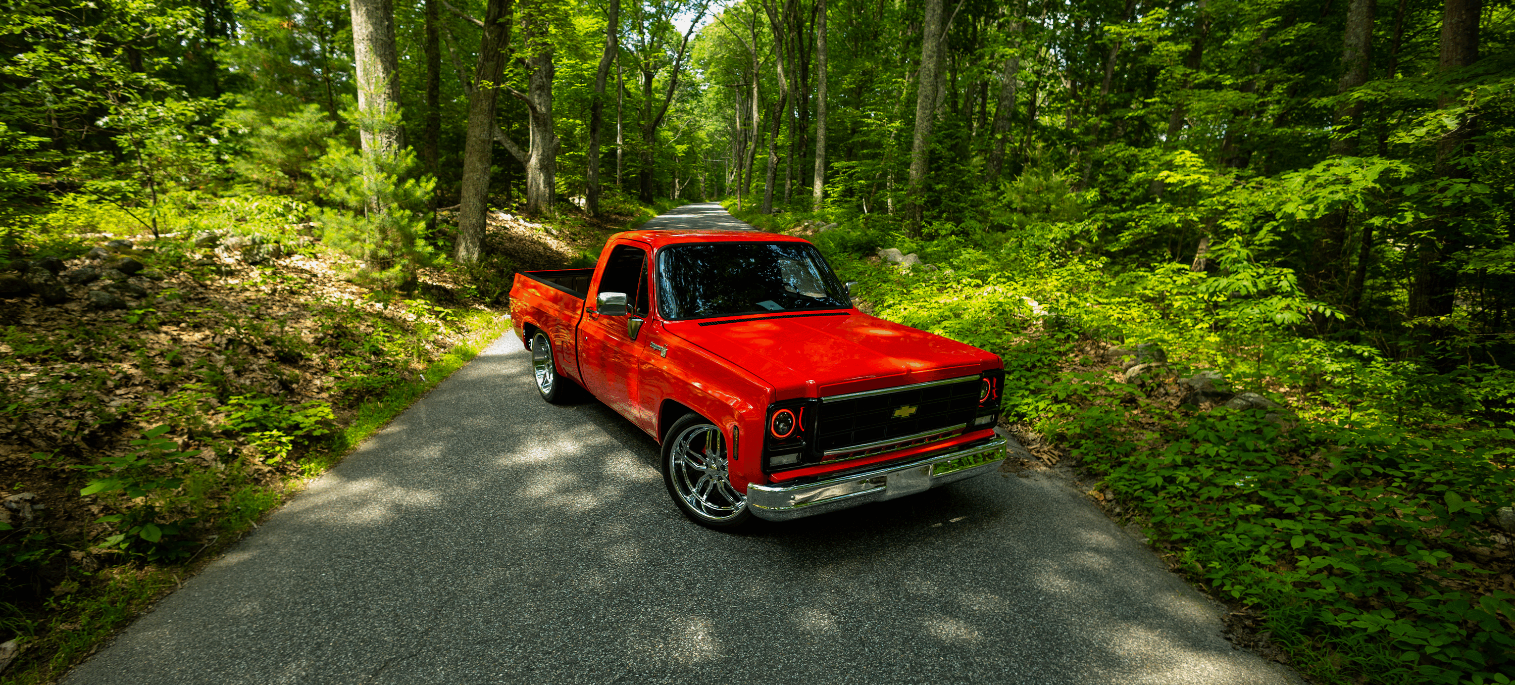 Red C10 pickup on forest road
