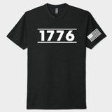 Black t-shirt with '1776' printed on it and a small American flag on the sleeve against a white background.
