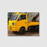 JRB7 custom yellow mini truck canvas with an open bed carrying a large log in a forest setting
