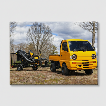 JRB7 custom yellow mini truck canvas with a trailer on a grassy field with trees in the background