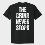 Black t-shirt with 'The Grind Never Stops' text on a white background