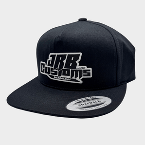 Black snapback cap with white logo on a light gray background