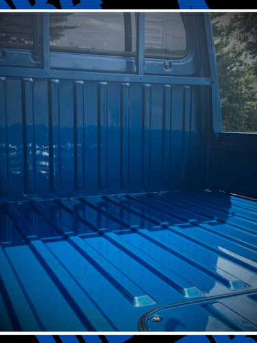 Blue truck bed with tire and side view on a blue background