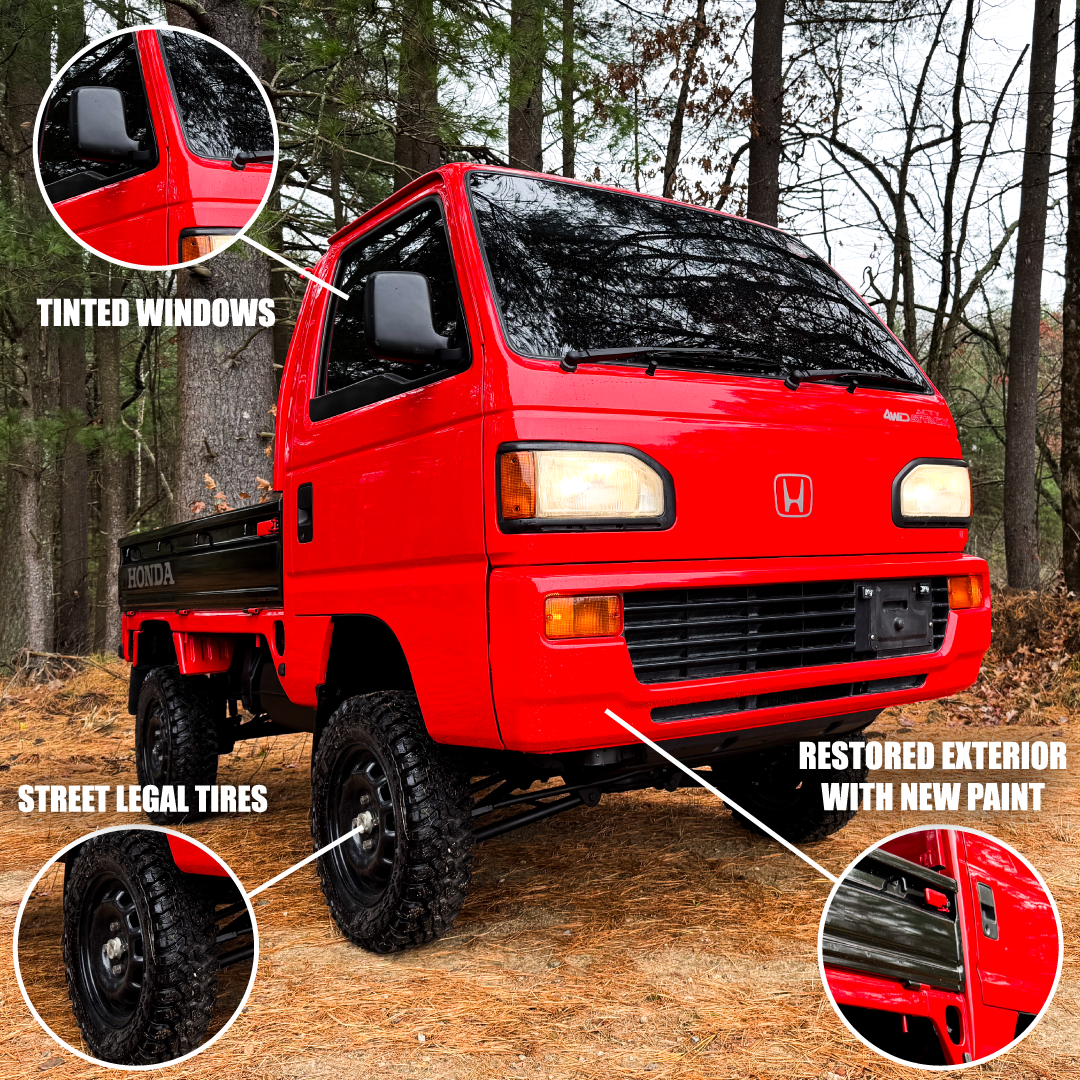 Red Honda truck with features highlighted in a forest setting