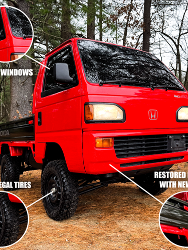 Red Honda truck with features highlighted in a forest setting