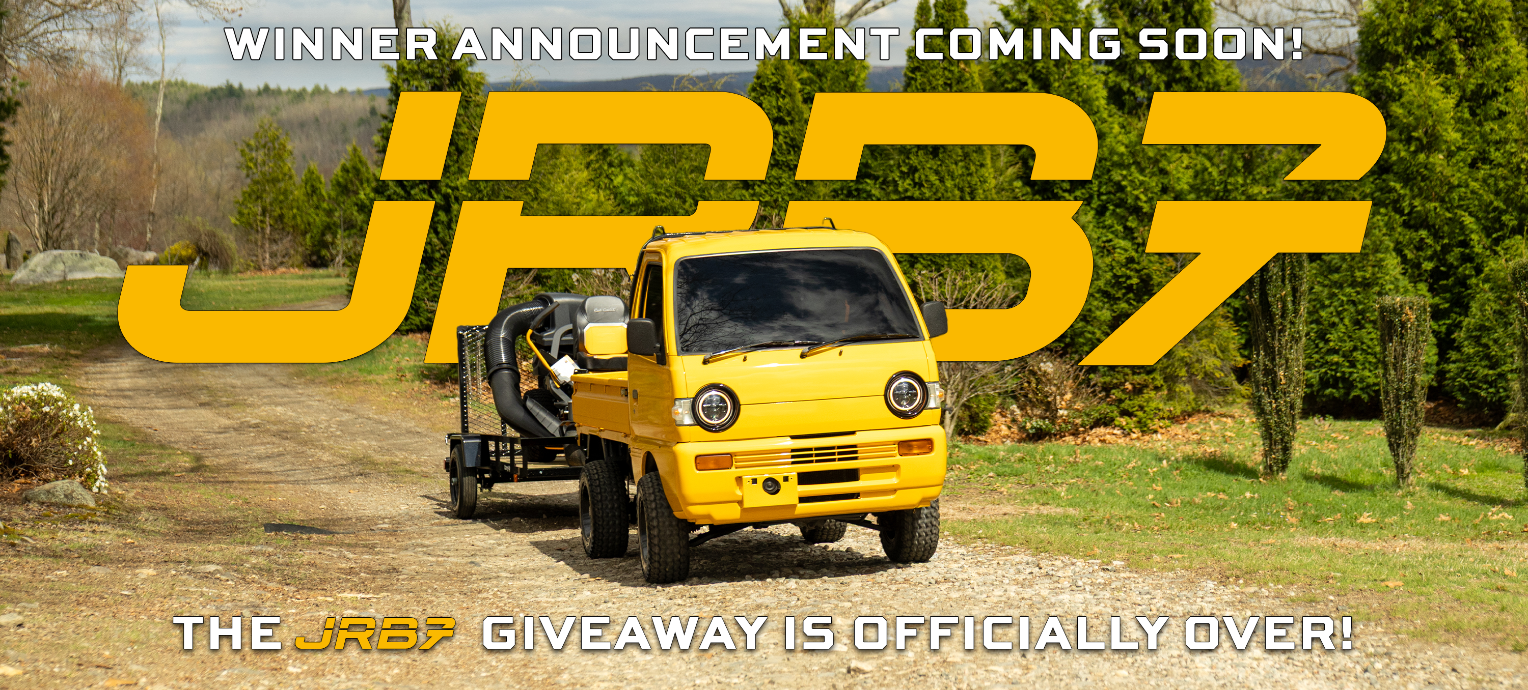 Yellow truck with a trailer on a dirt road, surrounded by trees, with text about JRB7 giveaway has ended, winner announcement coming soon.