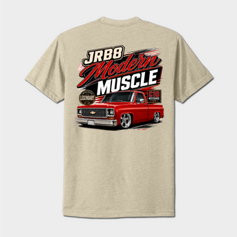 A light heather beige t-shirt shown from the back, featuring a large graphic print of a red classic muscle truck with 'JRB8 Modern Muscle' text and a 'Chevrolet' emblem.