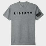 Gray t-shirt with 'LIBERTY' text and American flag sleeve on a white background