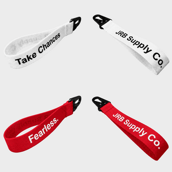 Two white lanyards with 'Take Chances' text and two red lanyards with 'JRB Supply Co.' text on a white background.