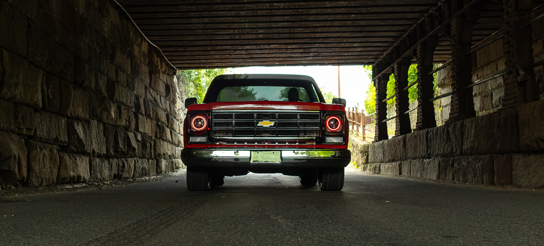 Red C10 pickup under bridge rear